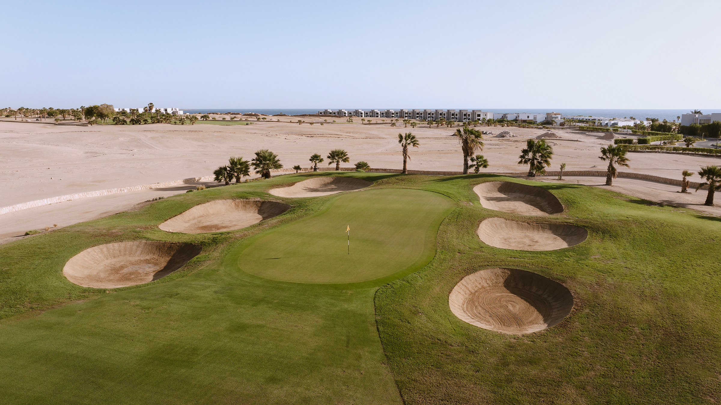 Soma Bay Golf Club: Wüstenpanorama, tiefe Bunker und Palmen, die das Green säumen